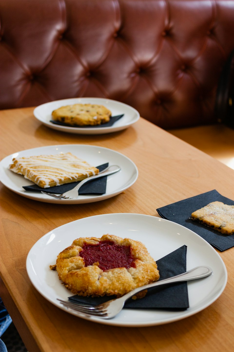 Pastries and cookie arranged on a wooden table.